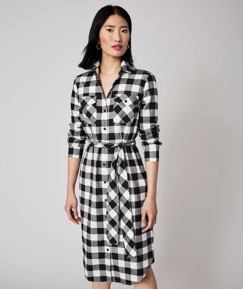 Model is wearing UNTUCKit Colby dress in black plaid.