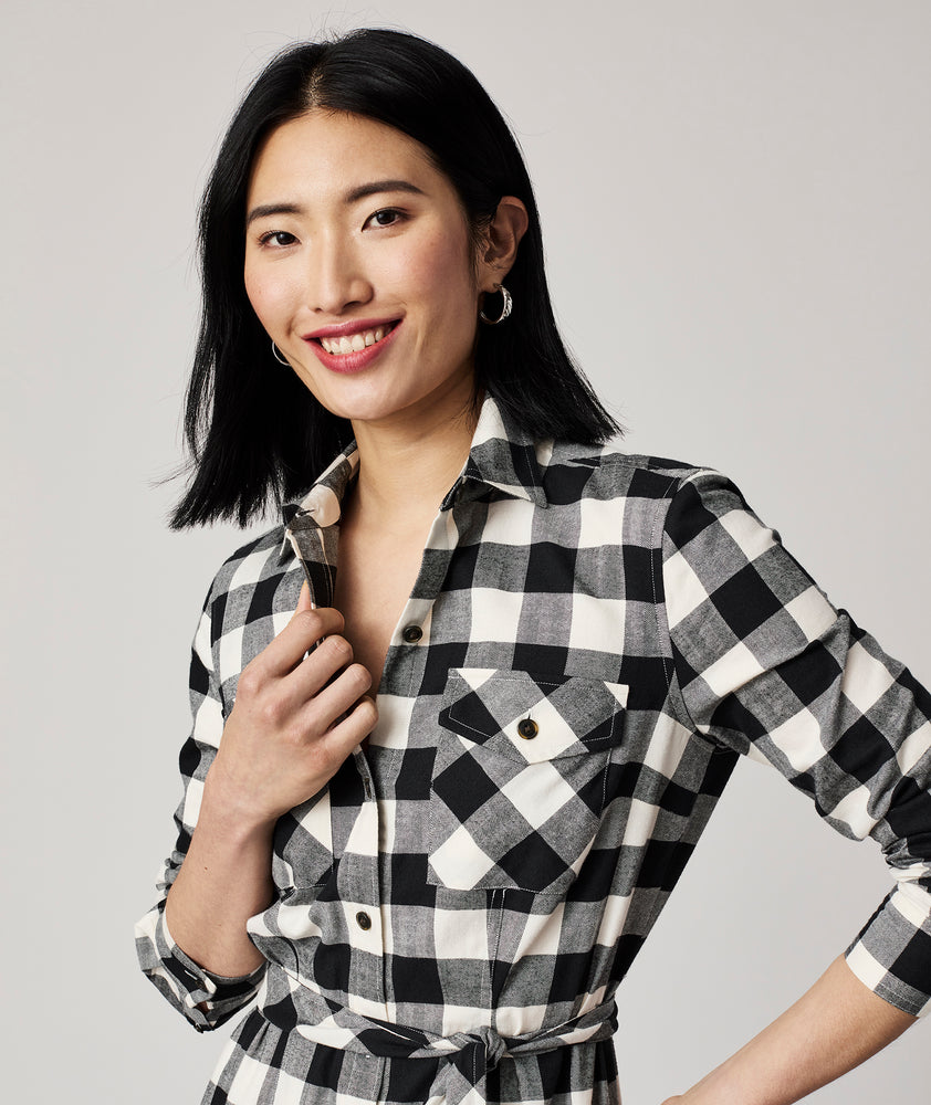 Model is wearing UNTUCKit Colby dress in black plaid.