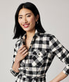 Model is wearing UNTUCKit Colby dress in black plaid.