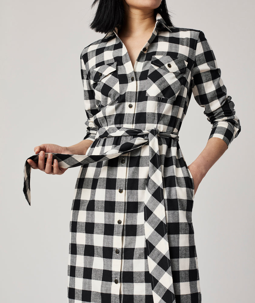 Model is wearing UNTUCKit Colby dress in black plaid.
