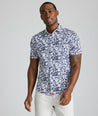 Model is wearing UNTUCKit Conner performance shirt in navy print. 