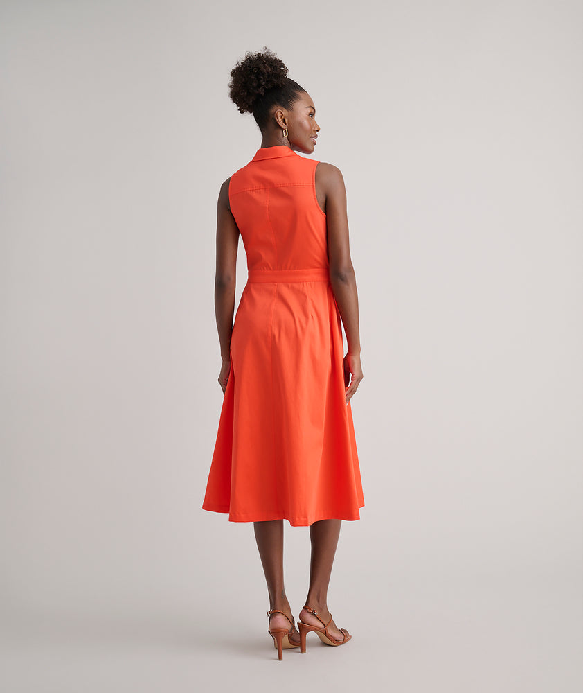 Model is wearing UNTUCKit Codelia dress in solid orange. 