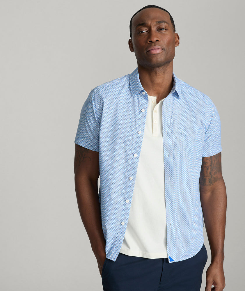 Model is wearing UNTUCKit Crofton performance shirt in blue. 