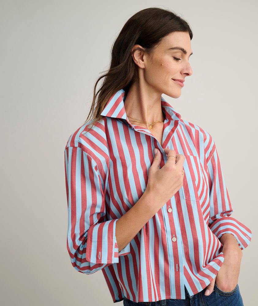 Model is wearing UNTUCKit Crosby shier in red and blue stripes. 