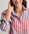 Model is wearing UNTUCKit Crosby shier in red and blue stripes. 