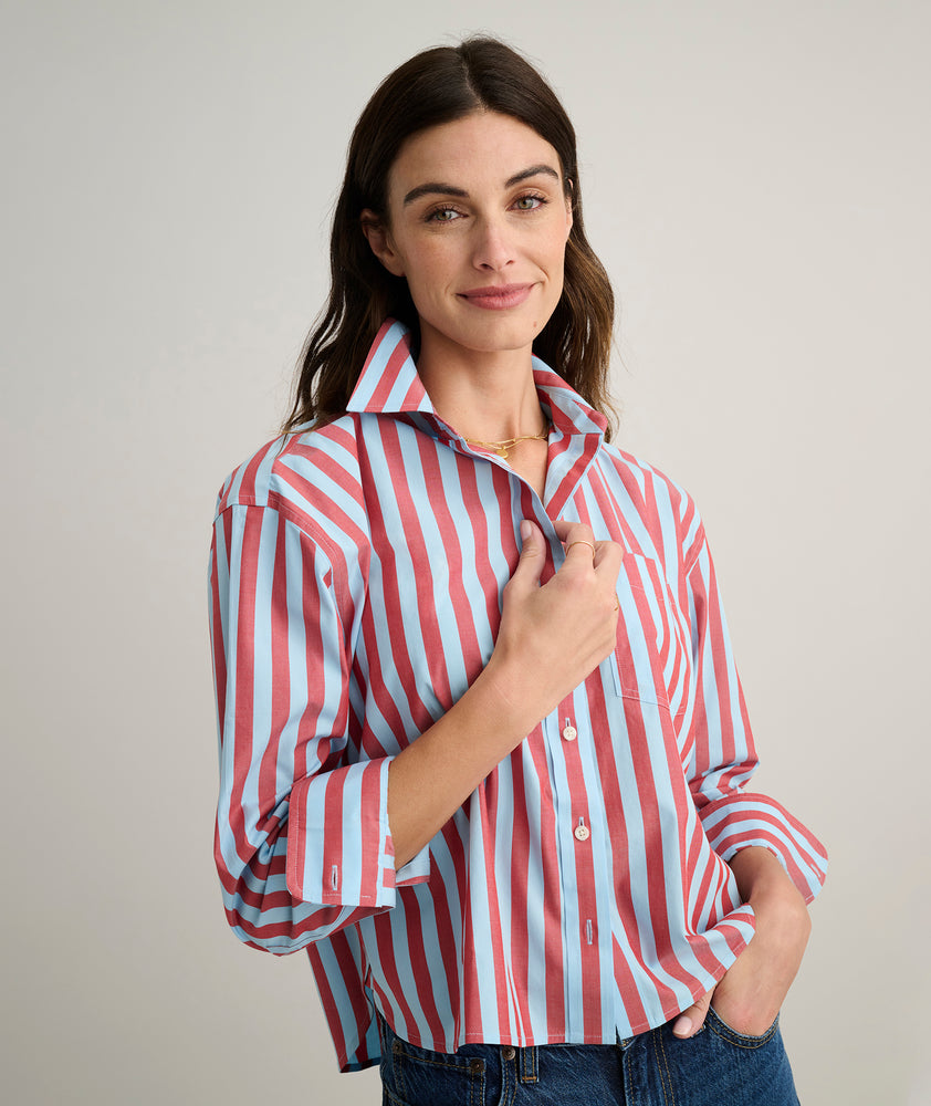 Model is wearing UNTUCKit Crosby shier in red and blue stripes. 