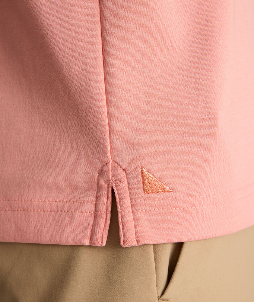Model is wearing UNTUCKit damaschino in solid coral haze. 