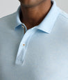Model is wearing UNTUCKit Wrinkle-Free Damaschino Polo in heather blue. 