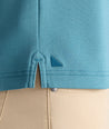 Model is wearing UNTUCKIt Wrinkle-Free Damaschino Polo in teal. 