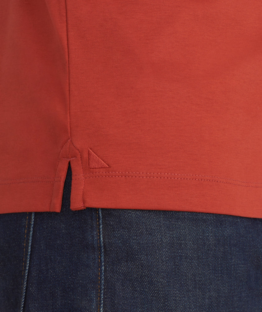 Model is wearing UNTUCKit damaschino long sleeve polo in solid chili.