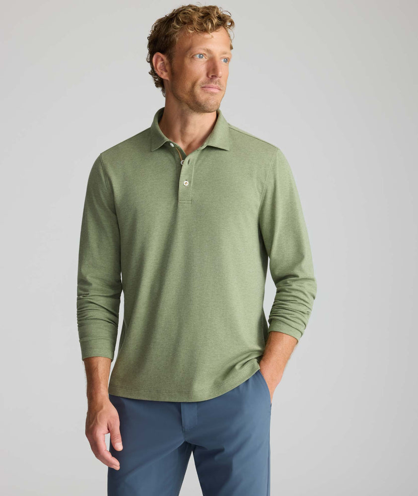 Model is wearing UNTUCKit Wrinkle-Free Damaschino Long-Sleeve Polo in Heather Sage. 
