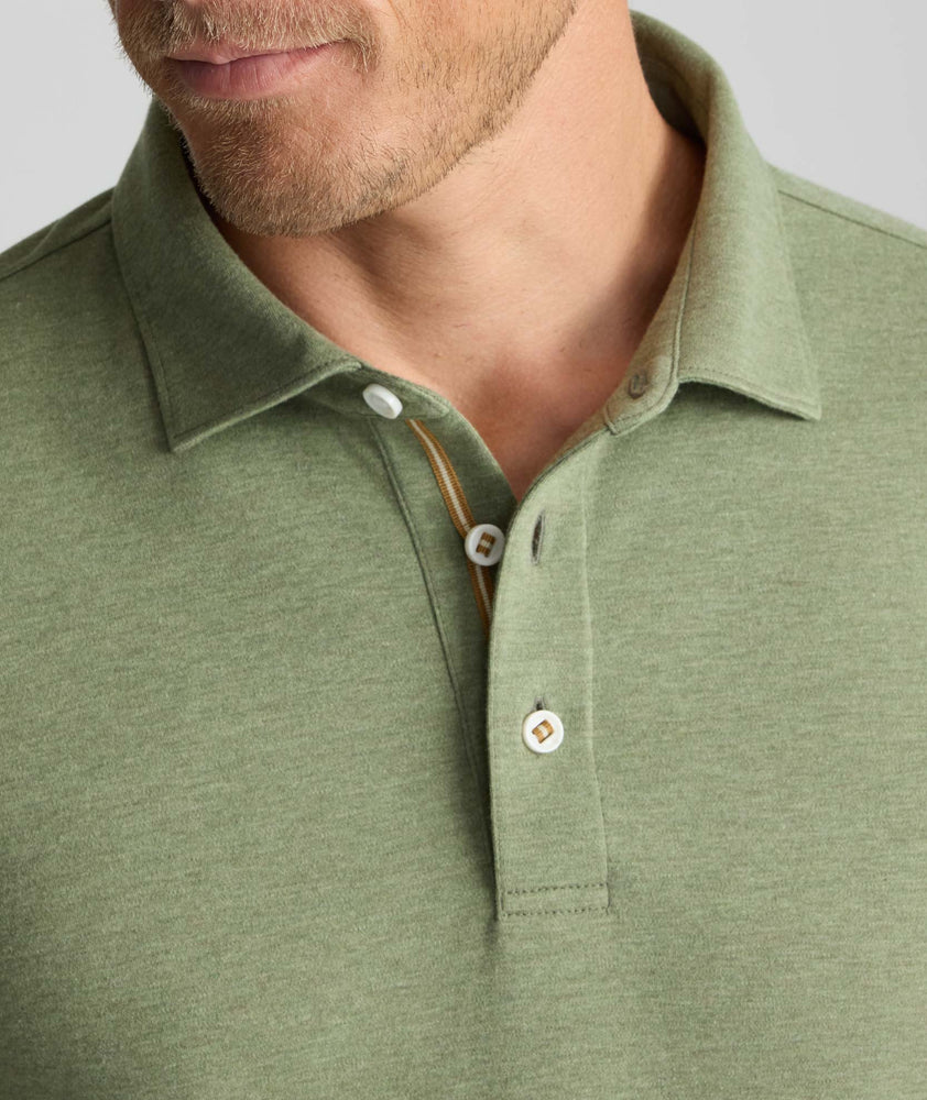 Model is wearing UNTUCKit Wrinkle-Free Damaschino Long-Sleeve Polo in Heather Sage. 
