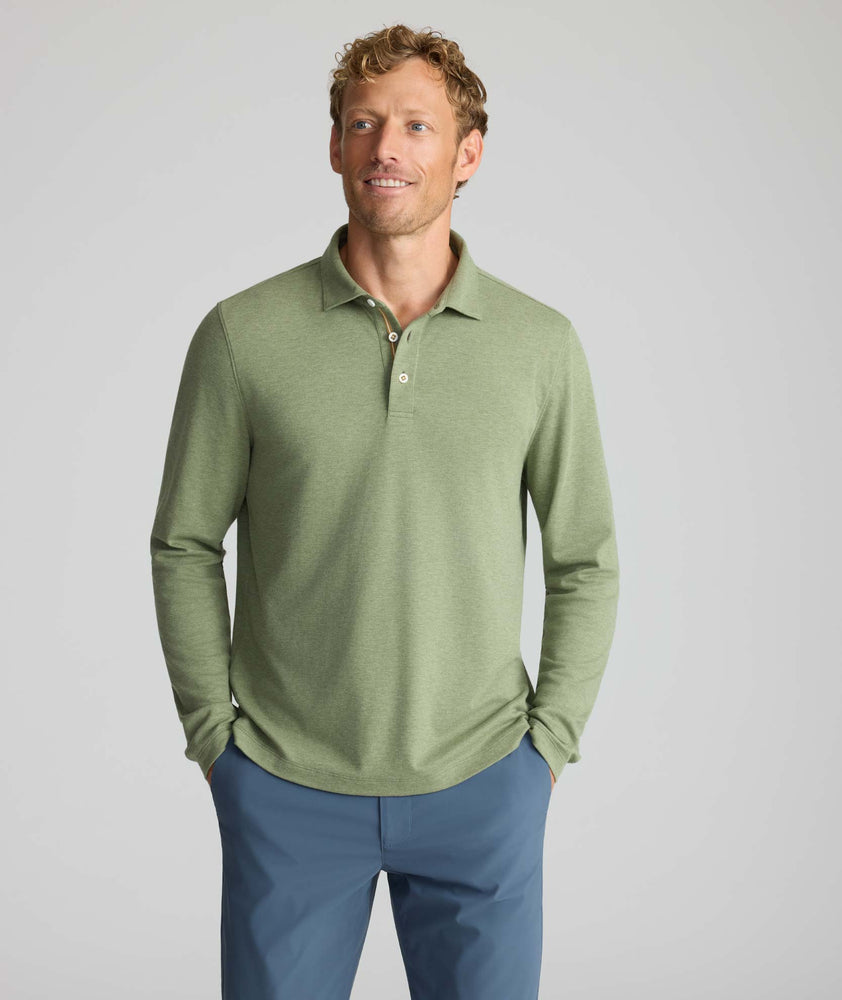 Model is wearing UNTUCKit Wrinkle-Free Damaschino Long-Sleeve Polo in Heather Sage. 