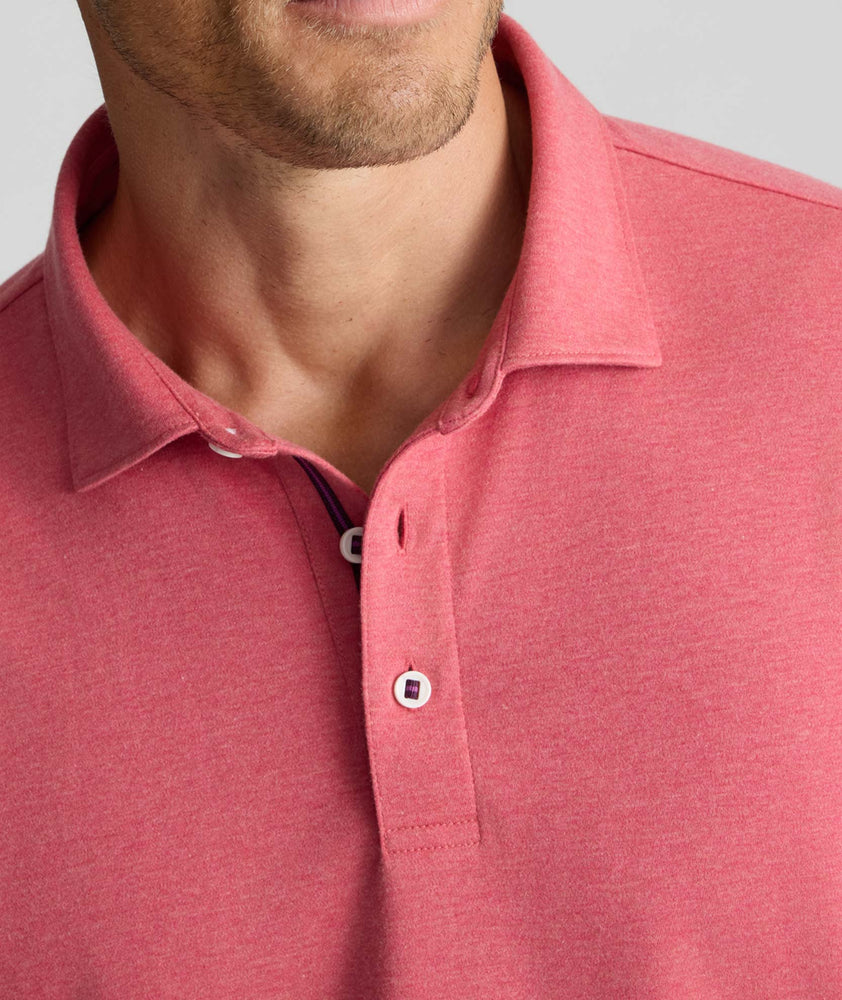 Model is wearing UNTUCKit Wrinkle-Free Damaschino Long-Sleeve Polo in Heather Pink. 