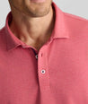 Model is wearing UNTUCKit Wrinkle-Free Damaschino Long-Sleeve Polo in Heather Pink. 