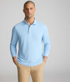 Model is wearing UNTUCKit Wrinkle-Free Damaschino Long-Sleeve Polo in Heather Light Blue. 