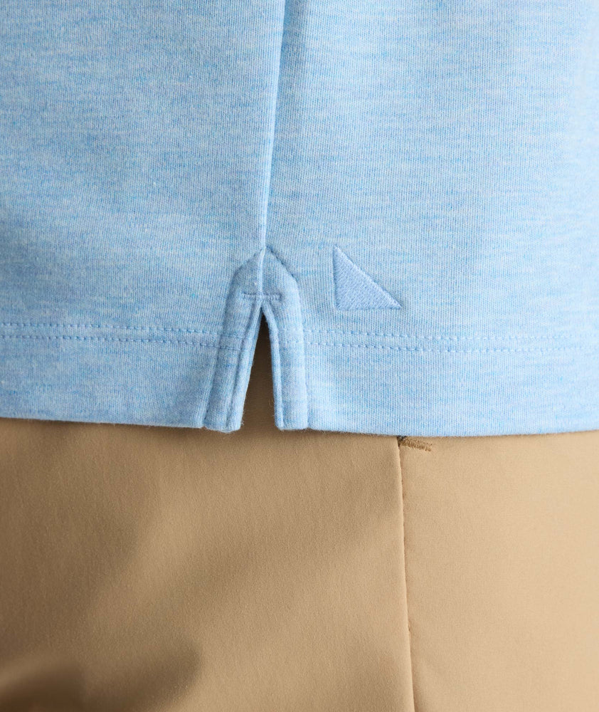 Model is wearing UNTUCKit Wrinkle-Free Damaschino Long-Sleeve Polo in Heather Light Blue. 