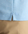 Model is wearing UNTUCKit Wrinkle-Free Damaschino Long-Sleeve Polo in Heather Light Blue. 