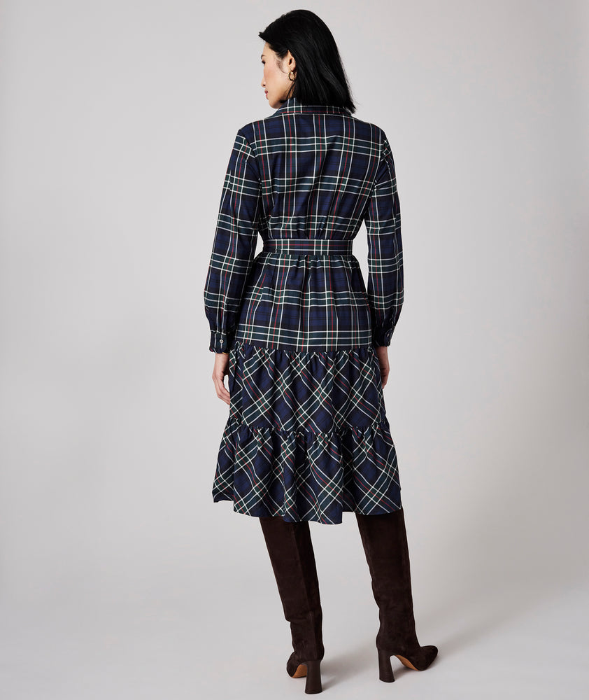 Model is wearing UNTUCKit Dara dress in navy plaid.