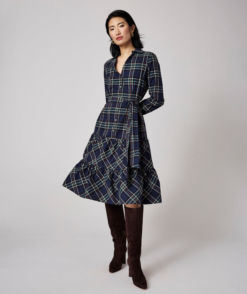 Model is wearing UNTUCKit Dara dress in navy plaid. 