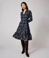 Model is wearing UNTUCKit Dara dress in navy plaid. 