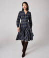 Model is wearing UNTUCKit Dara dress in navy plaid.