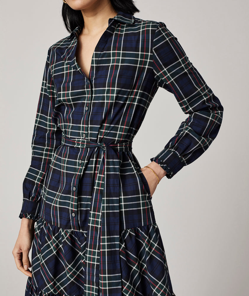 Model is wearing UNTUCKit Dara dress in navy plaid.