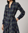 Model is wearing UNTUCKit Dara dress in navy plaid.