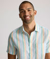 Model is wearing UNTUCKit darby wrinkle-free shirt in rainbow stripe. 