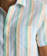 Model is wearing UNTUCKit darby wrinkle-free shirt in rainbow stripe. 