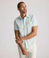 Model is wearing UNTUCKit darby wrinkle-free shirt in rainbow stripe. 