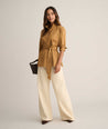 Model is wearing UNTUCKit Stretch Cotton Belted Popover Darcy Shirt. 