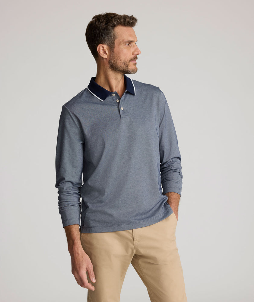 Model is wearing UNTUCKit LS Day Performance Polo in Evening Blue.