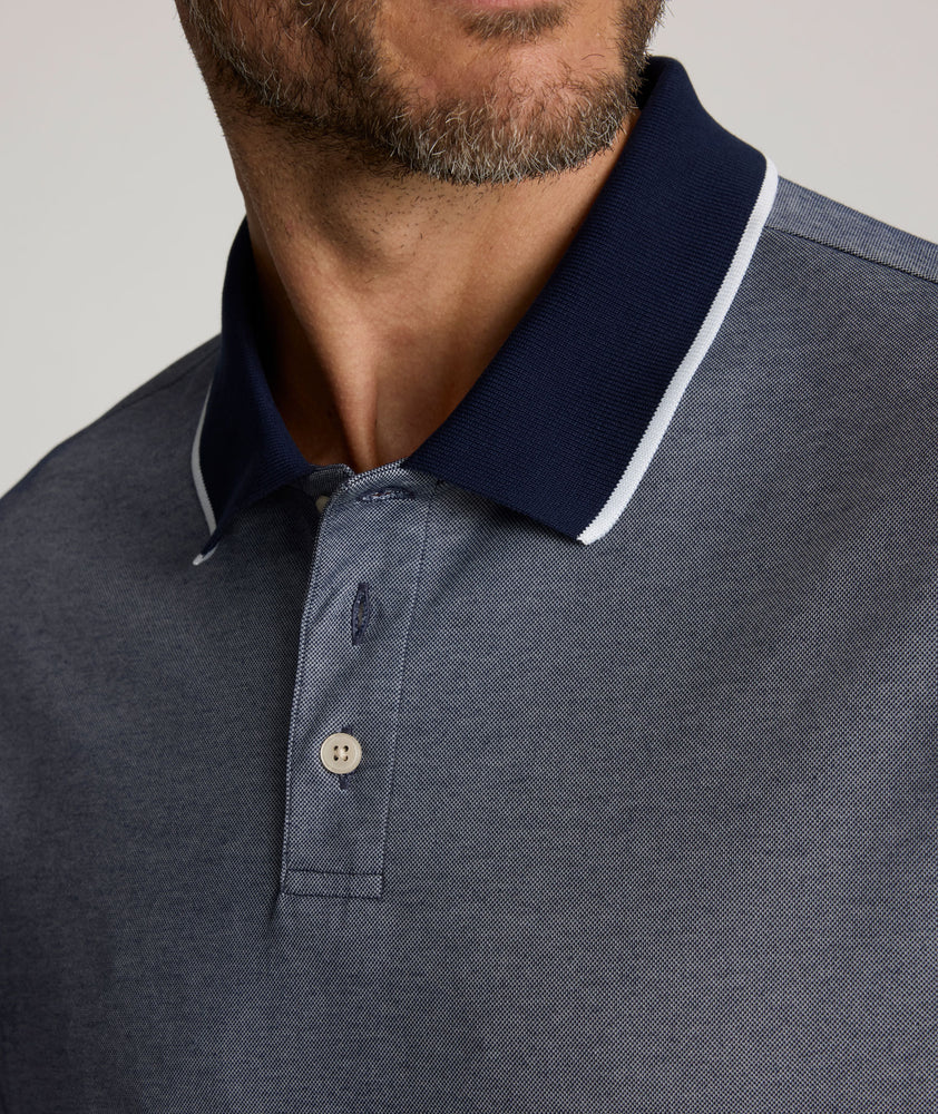 Model is wearing UNTUCKit LS Day Performance Polo in Evening Blue.