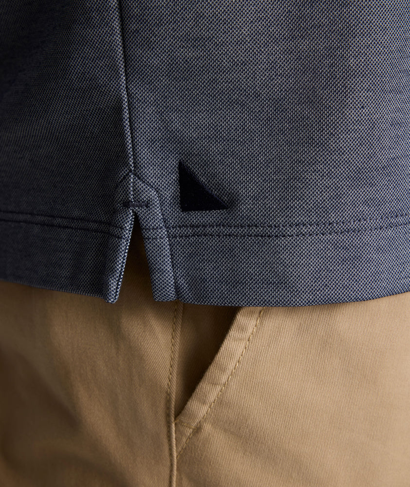 Model is wearing UNTUCKit LS Day Performance Polo in Evening Blue.