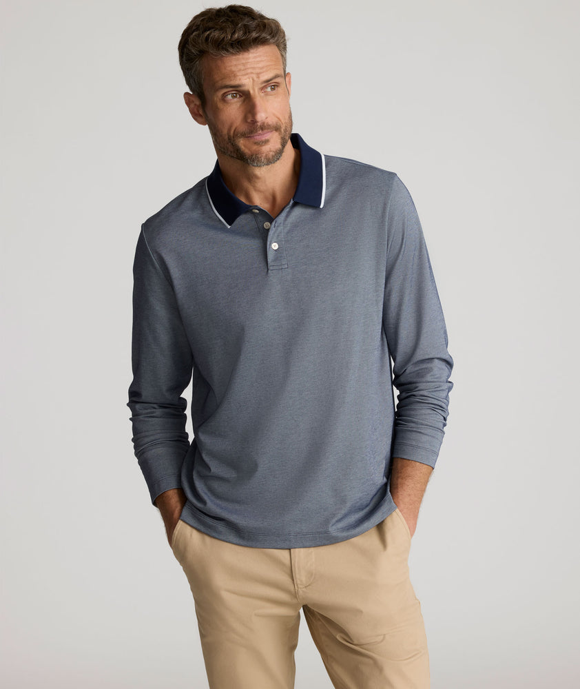 Model is wearing UNTUCKit LS Day Performance Polo in Evening Blue.