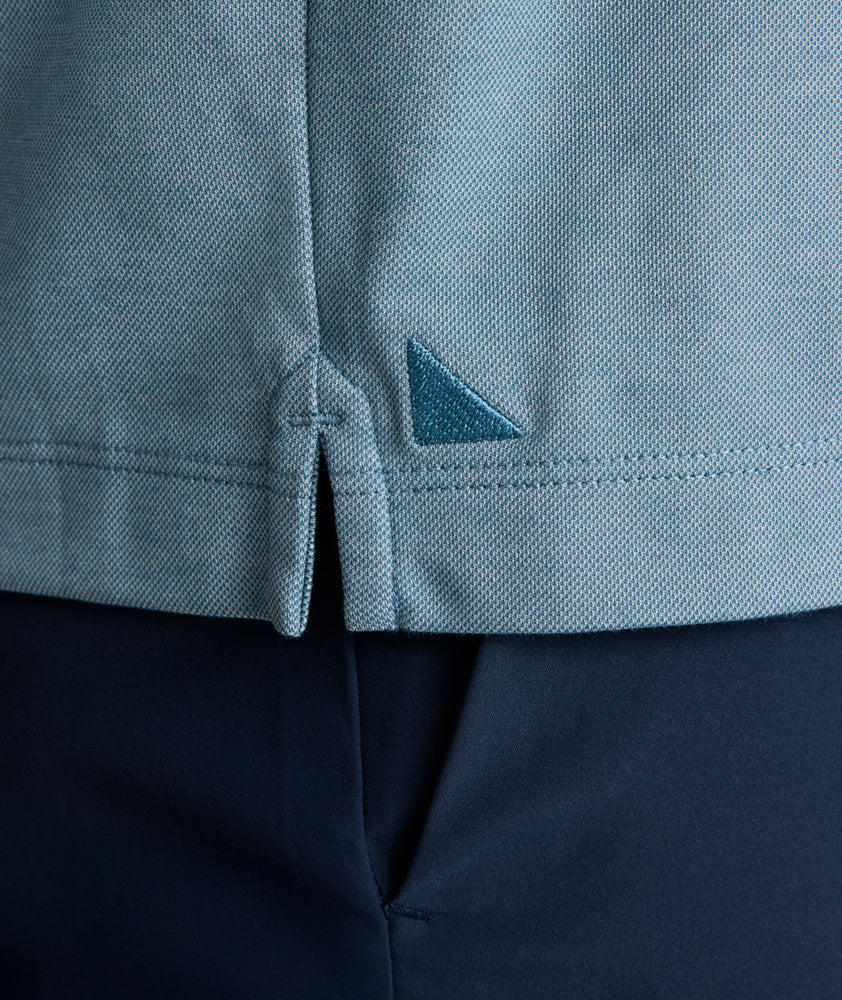 Model is wearing UNTUCKit LS Day Performance Polo in Real Teal.