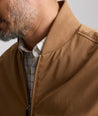 Model is wearing UNTUCKit Cotton Blend Bomber Jacket in tan. 