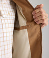 Model is wearing UNTUCKit Cotton Blend Bomber Jacket in tan. 