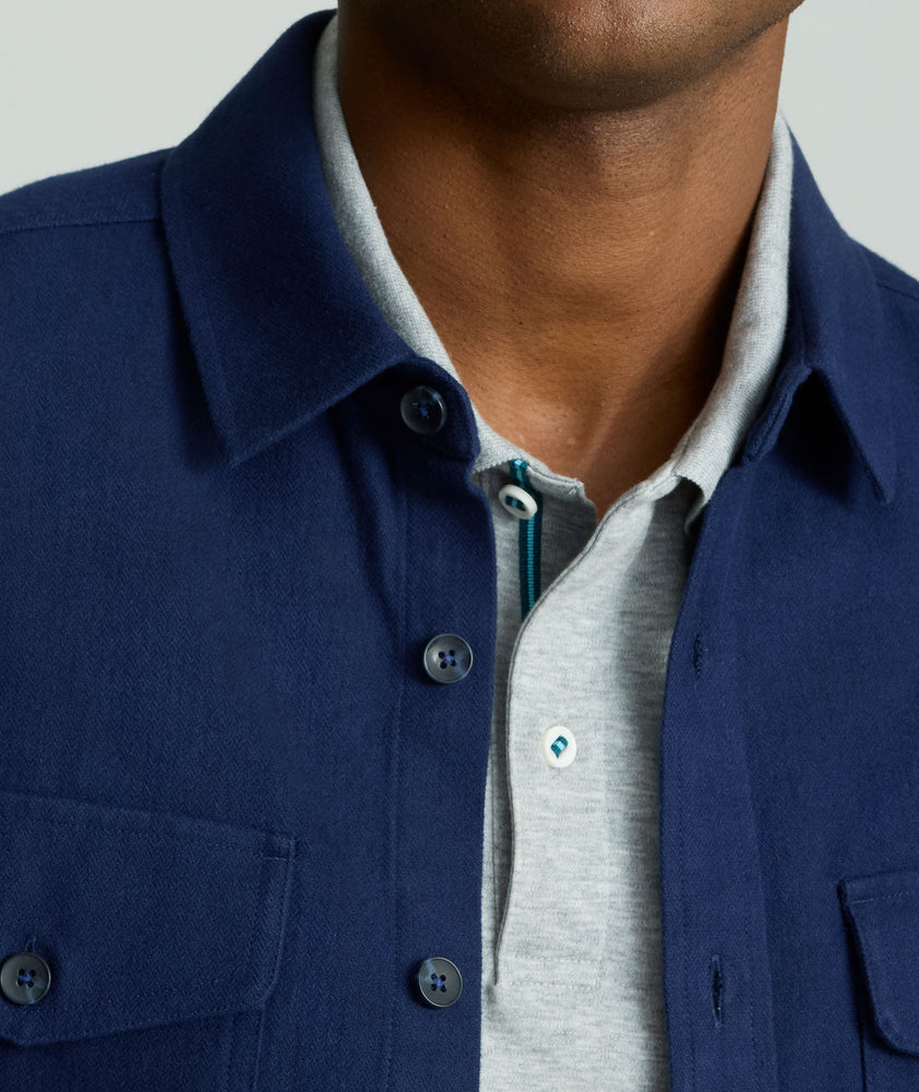 Model is wearing UNTUCKit Brushed Overshirt in navy. 