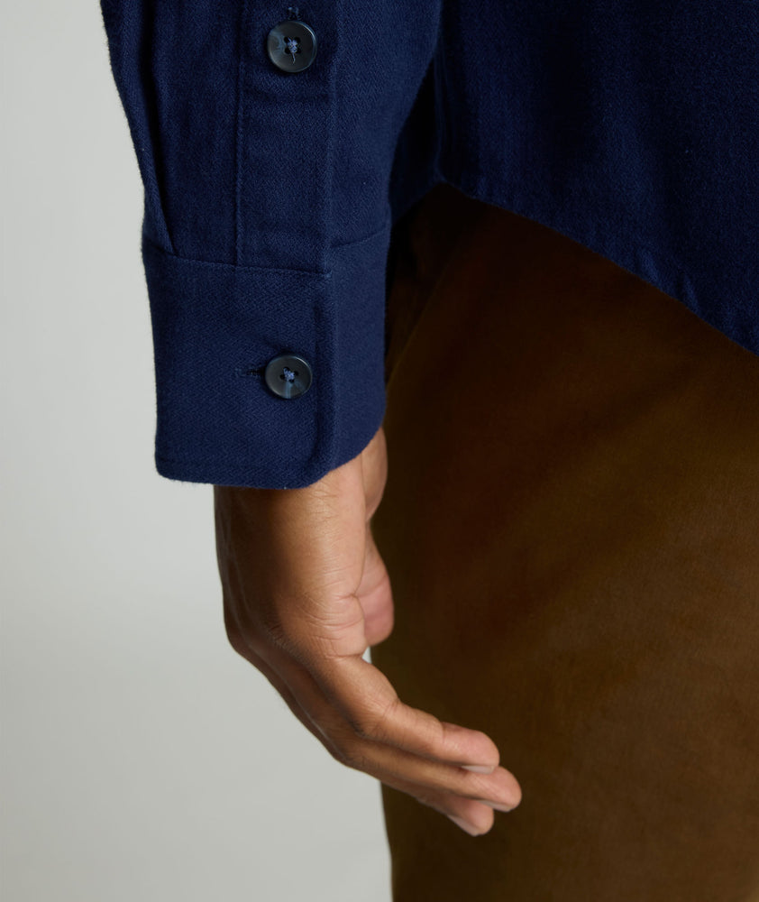 Model is wearing UNTUCKit Brushed Overshirt in navy. 