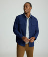 Model is wearing UNTUCKit Brushed Overshirt in navy. 