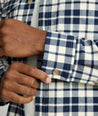 Model is wearing UNTUCKit Brushed Overshirt in navy and white check. 