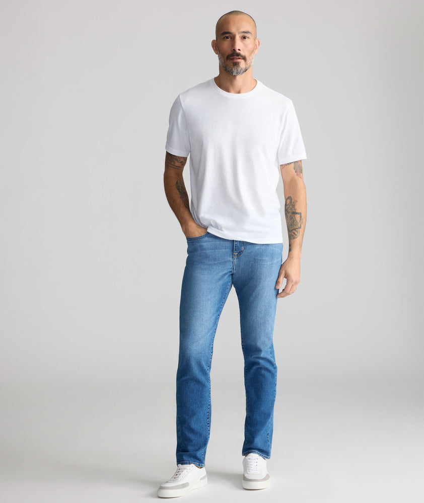 Model is wearing UNTUCKit denim in rinse. 