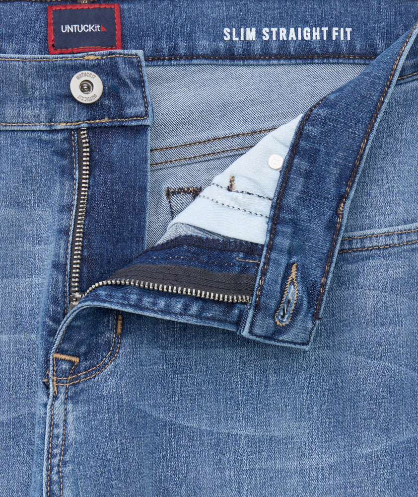 Model is wearing UNTUCKit denim in rinse. 