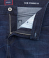 Close-up of a blue denim jacket with 'Untuckit' branding and 'Slim Straight Fit' text.