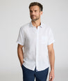 Model is wearing UNTUCKit Dixon short sleeve shirt with white grounded Dimond print. 
