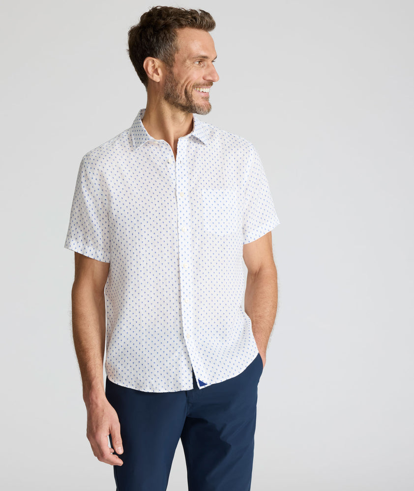 Model is wearing UNTUCKit Dixon short sleeve shirt with white grounded Dimond print. 