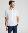 Model is wearing UNTUCKit Dixon short sleeve shirt with white grounded Dimond print. 