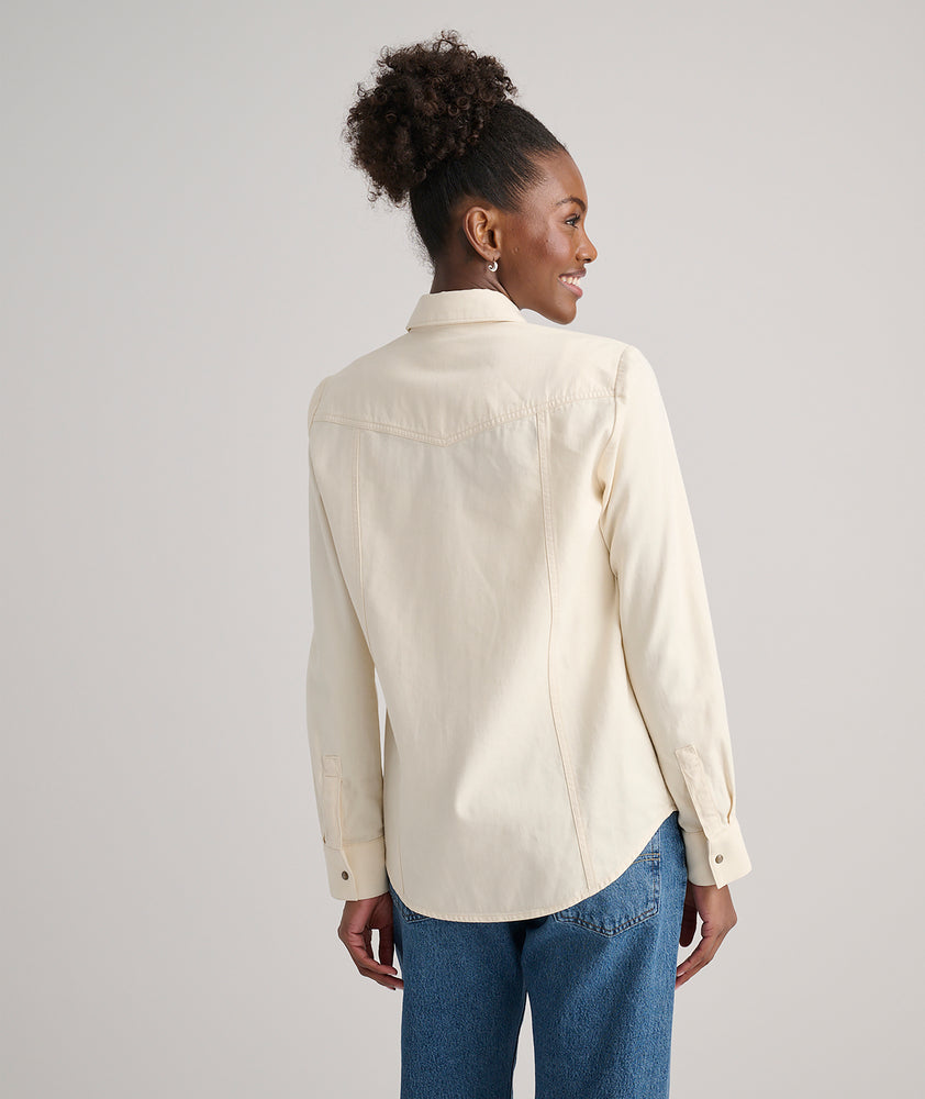Model is wearing UNTUCKit Dolly shirt in Ecru.